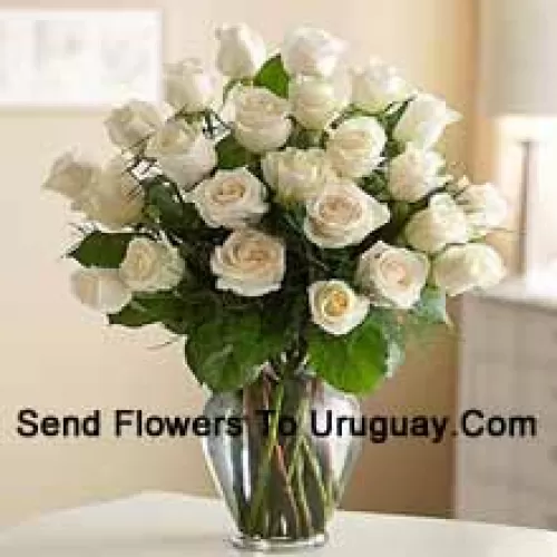 24 White Roses With Some Ferns In A Glass Vase