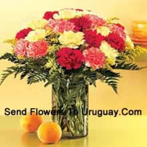 24 Mixed Colored Carnations With Seasonal Fillers In A Glass Vase