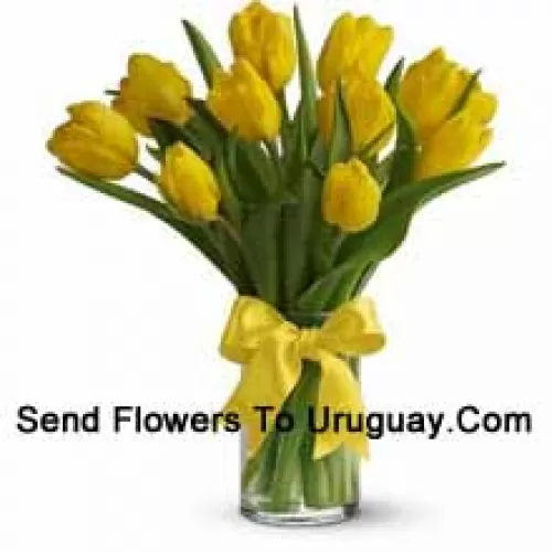 Yellow Tulips With Seasonal Fillers And Leaves In A Glass Vase - Please Note That In Case Of Non-Availability Of Certain Seasonal Flowers The Same Will Be Substituted With Other Flowers Of Same Value