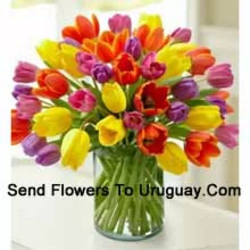 Mixed Colored Tulips In A Glass Vase - Please Note That In Case Of Non-Availability Of Certain Seasonal Flowers The Same Will Be Substituted With Other Flowers Of Same Value