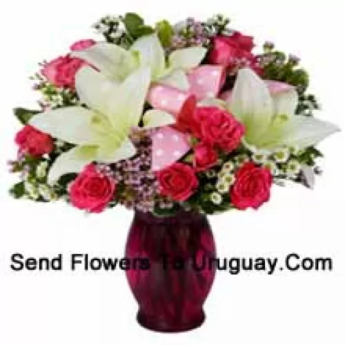 Pink Roses And White Lilies With Seasonal Fillers In A Glass Vase