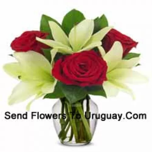 Red Roses And White Lilies With Seasonal Fillers In A Glass Vase