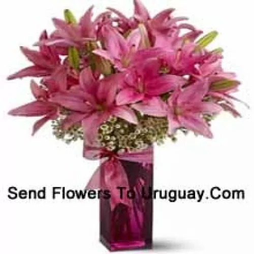 Beautiful Pink Lilies With Some Ferns In A Glass Vase