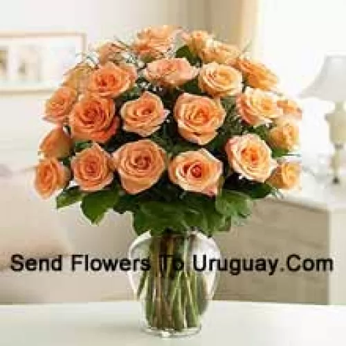 24 Peach Roses With Some Ferns In A Glass Vase