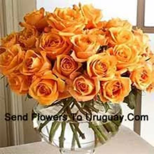 24 Orange Roses With Some Ferns In A Glass Vase