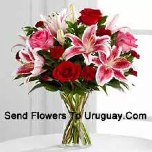 Red And Pink Roses With Pink Lilies And Seasonal Fillers In A Glass Vase