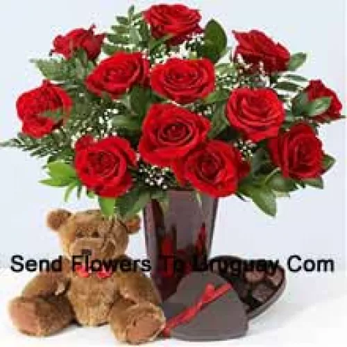 12 Red Roses With Some Ferns In A Vase, Cute Brown 10 Inches Teddy Bear And A Heart Shaped Chocolate Box.