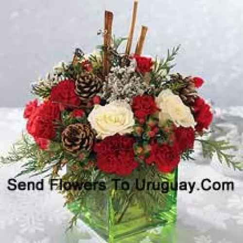 Send this bouquet of holiday colours - white roses, red carnations and Christmas greens - to express your happiest holiday wishes. Arranged in a glass cube with cinnamon sticks and pinecones, it's a wonderful gift for anyone on your list (Please Note That We Reserve The Right To Substitute Any Product With A Suitable Product Of Equal Value In Case Of Non-Availability Of A Certain Product)